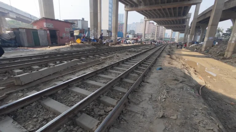 Railway tracks beneath an elevated road in Dhaka, Bangladesh