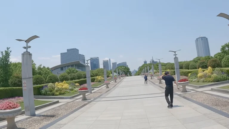 Wide riverside promenade with city towers in China