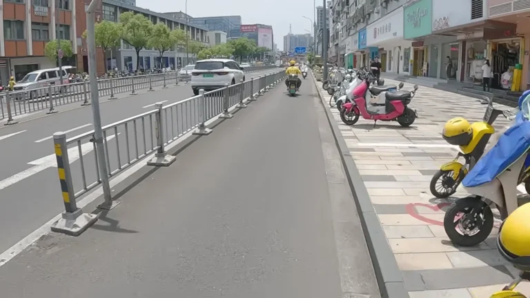 Busy city road with scooters and cyclists in China