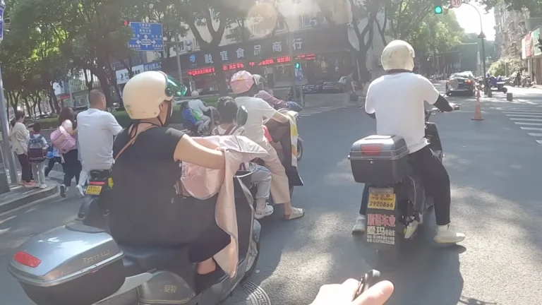 Riders on electric scooters in city traffic in China