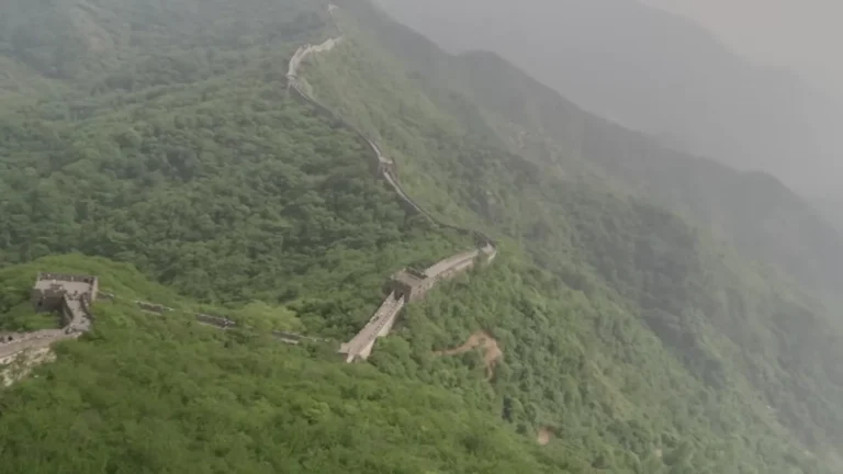 Ancient wall snaking across forested mountains in China