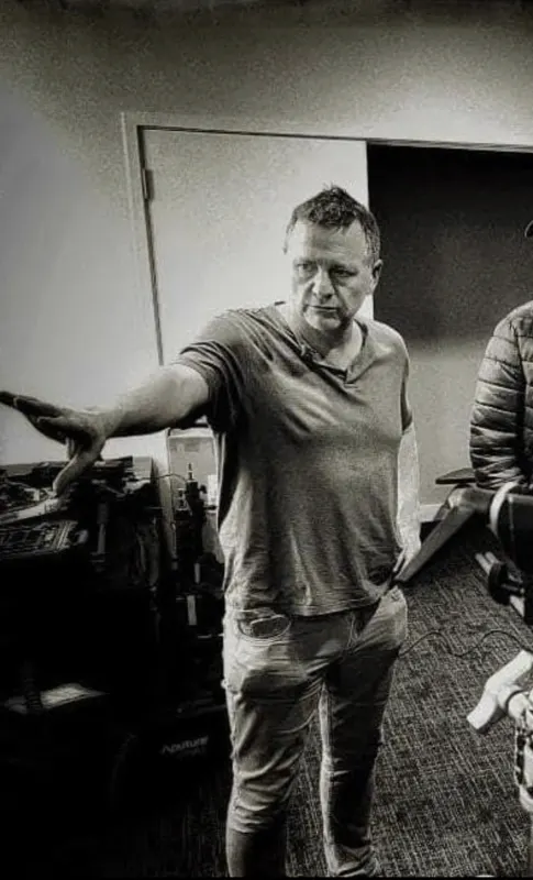 Andy Blithe directing on set, black and white, arm out giving direction