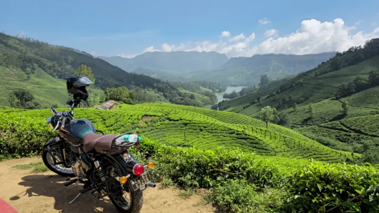 Motorbike parked above rolling tea plantations in Munnar, Kerala, India