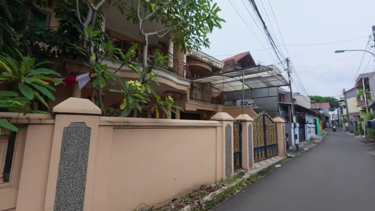 Street with gateposts and houses in Jakarta, Indonesia
