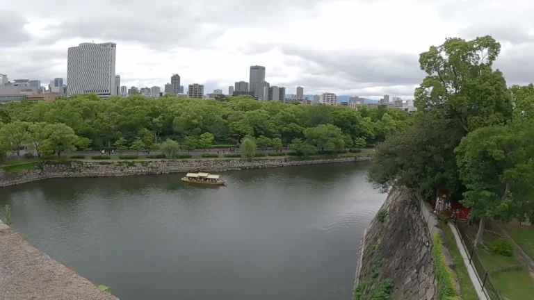 Castle moat with city towers beyond in Japan