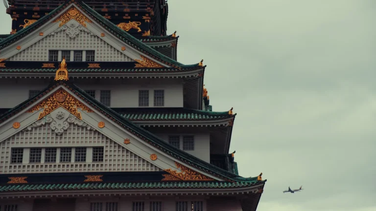 Ornate castle tower against a grey sky in Japan