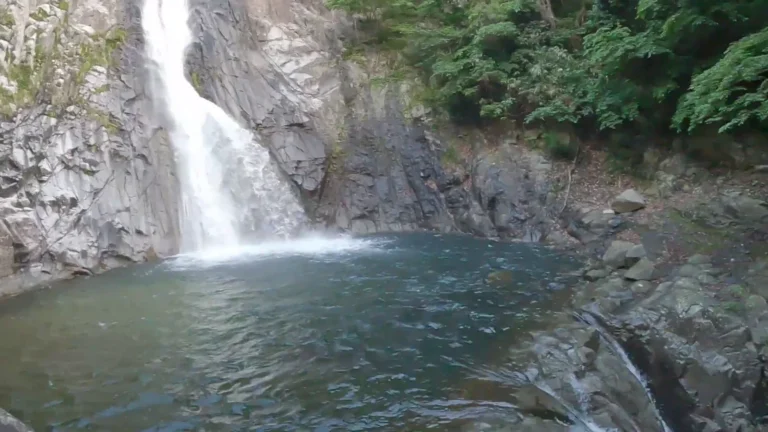 Waterfall pouring into a rocky pool in Japan