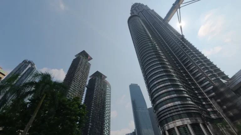 Looking up at twin towers against a blue sky in Kuala Lumpur, Malaysia