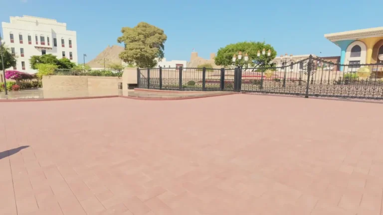 Wide paved square in front of grand buildings in Oman