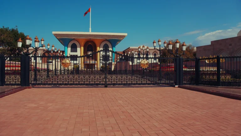 Colourful palace facade behind iron gates in Oman