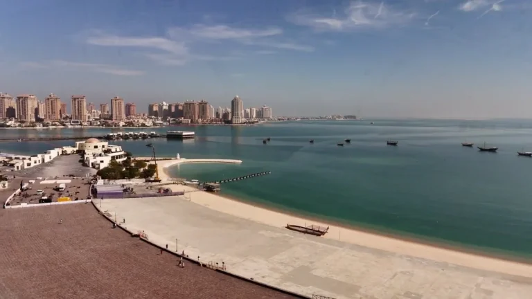Beach and city skyline across the water in Qatar