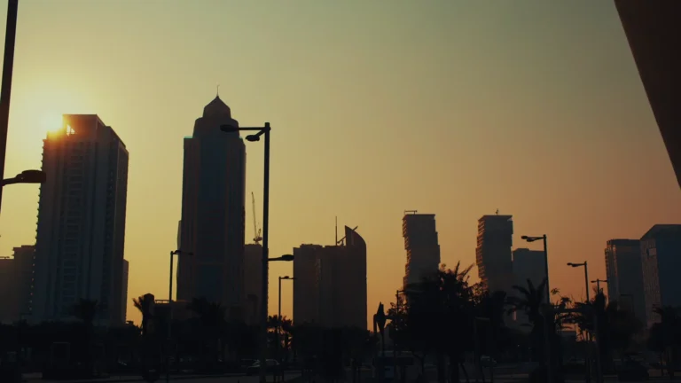 City towers silhouetted at sunset in Qatar