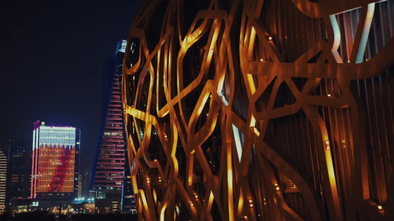 Illuminated lattice tower at night in Qatar