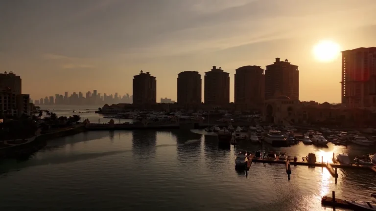 Sunset over a marina and apartment towers in Qatar