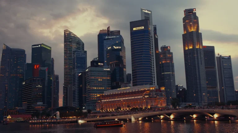 Skyline lit up at night across the water in Singapore