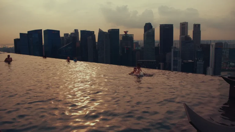 Skyline across a rooftop pool at sunset in Singapore