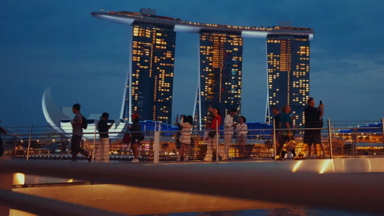 Three linked hotel towers lit up at night in Singapore