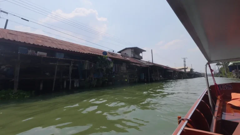 Wooden stilt houses along a canal in Thailand
