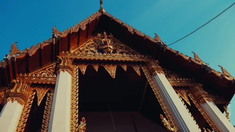 Ornate temple roof with gold carvings in Thailand