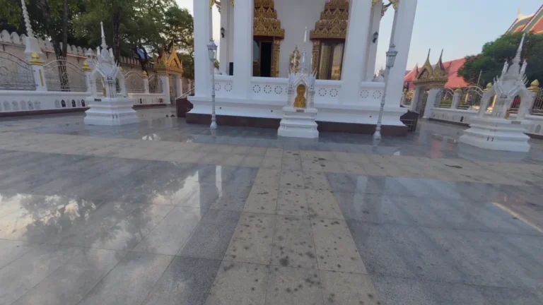 White temple buildings around a courtyard in Thailand