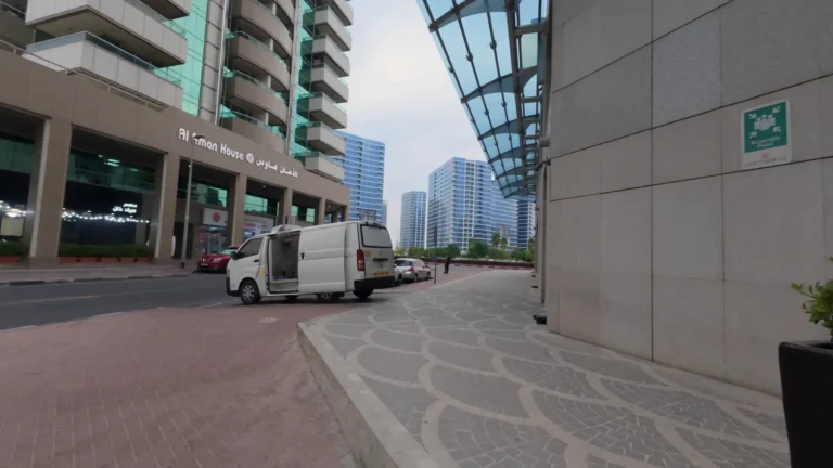 Street between tall buildings in Dubai, UAE
