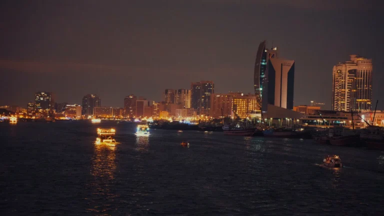 City skyline across the creek at night in Dubai, UAE