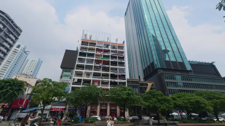 Colourful apartment block beside glass towers in Vietnam