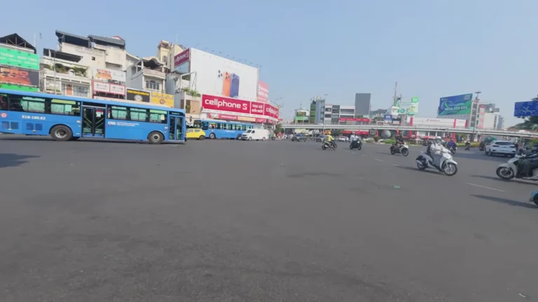 Wide city junction with buses and billboards in Vietnam