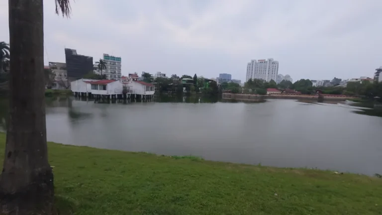Lake framed by trees and buildings in Vietnam